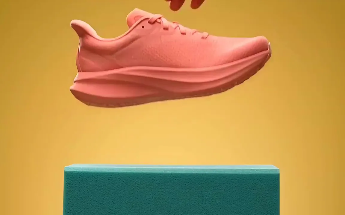 AI video of a coral pink running shoe landing on a turquoise foam block against a yellow backdrop