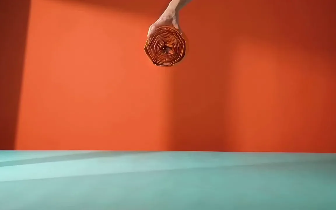 Gemini Omni video of an orange pop up tent springing open into a dome on a mint floor against a coral wall