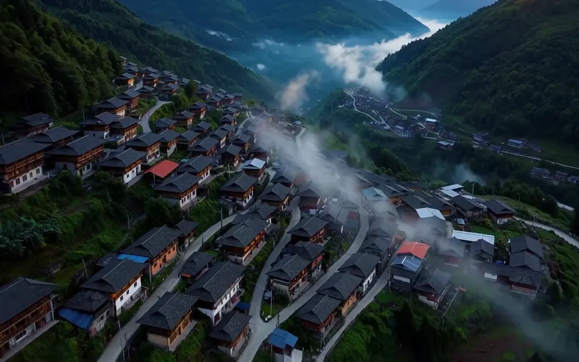 Luma Dream Machine video of dawn light reaching the rooftops of a misty mountain village