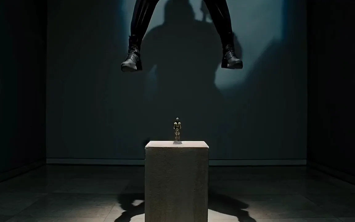 Runway Gen-4.5 video of a thief in black lowering on a rope to a bronze statuette on a stone pedestal