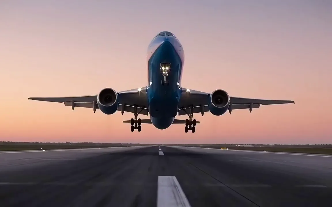 Wan 2.2 video of a blue airliner touching down on a runway at dusk with a puff of tyre smoke