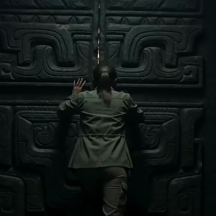 Seedance 2.0 video of an explorer pushing open carved stone doors as golden light floods through
