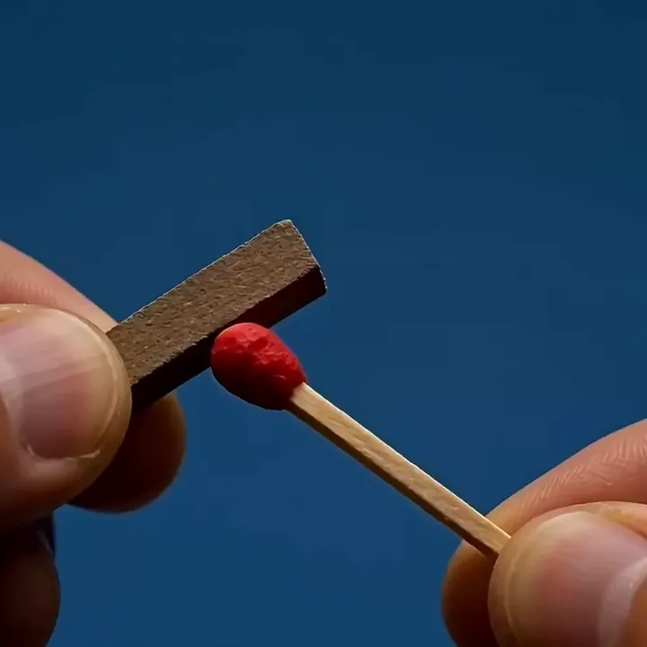 Wan 2.2 video of a matchstick bursting alight into a steady flame against deep blue