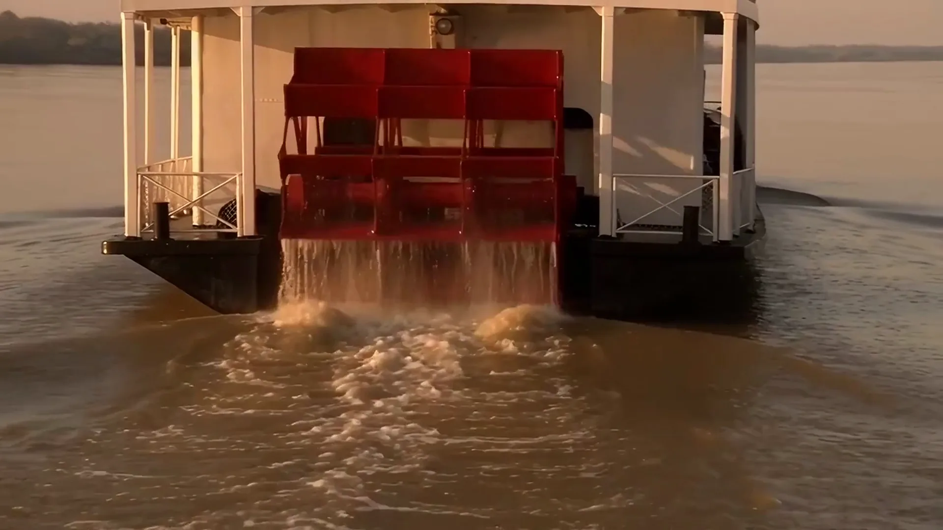 Wan AI video of a red paddle wheel churning a brown river at golden hour, A waterspout touching down beside an orange sea stack under a violet sky, Three toadstools glowing magenta and cyan on a mossy log at night, A crested porcupine stamping and raising its black and white quills on red earth