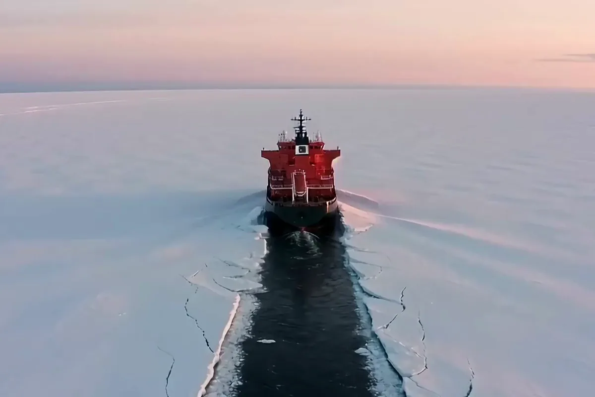 FLUX 3 video of a high drone shot following a red icebreaker cutting a black channel through white sea ice