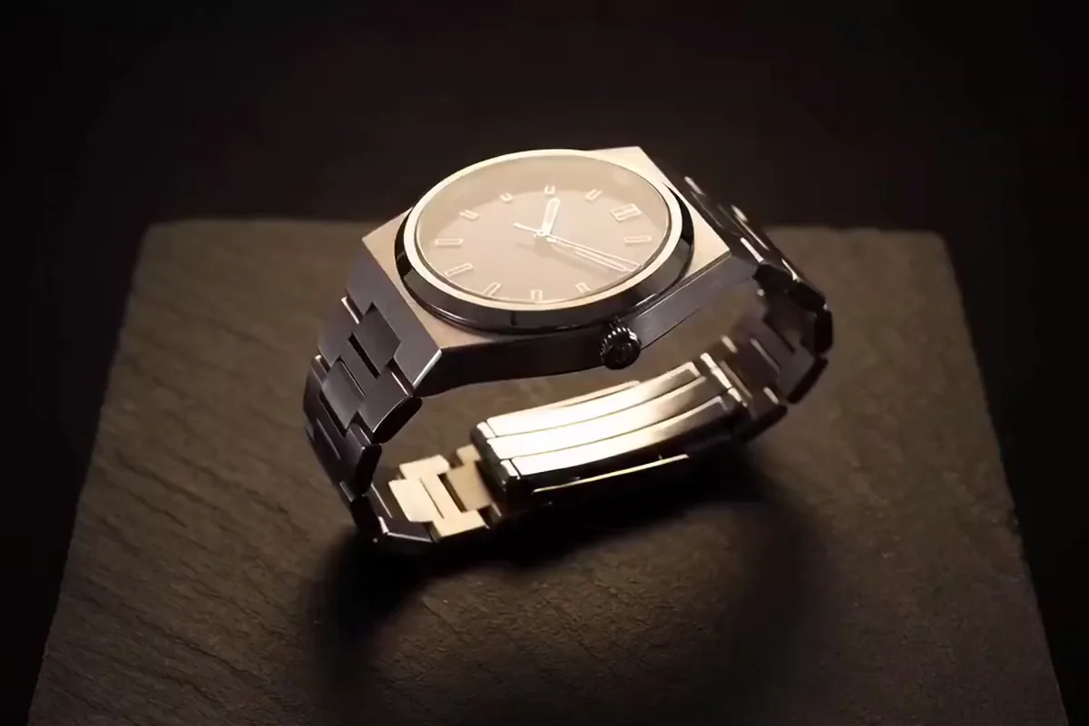 LTX-2 video of a steel watch turning on a slate block as a warm highlight slides across the dial
