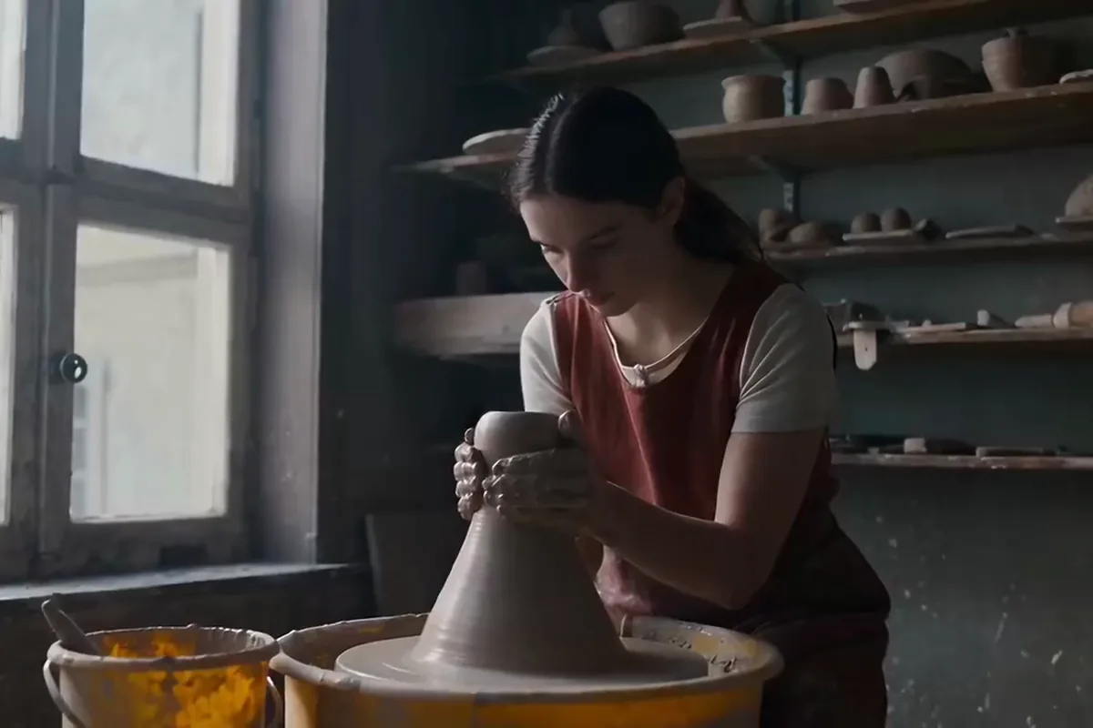 LTX-2 Turbo video of a potter shaping clay at her wheel by a bright studio window