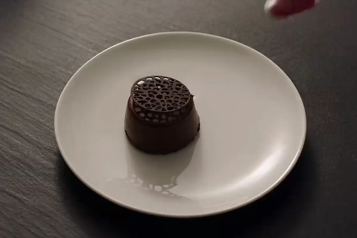 LTX-2 video of a chef's spoon bringing red berry sauce to a plate beside a chocolate dessert