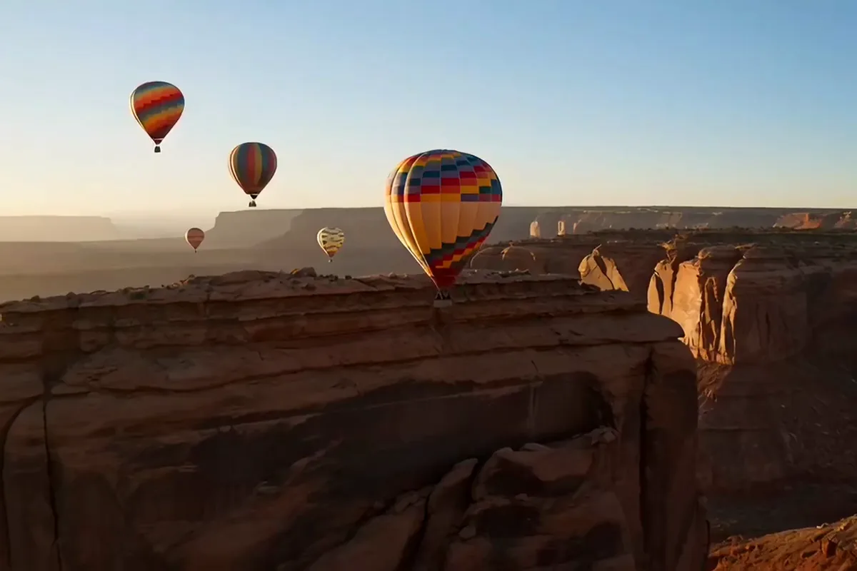 Luma Dream Machine video of hot air balloons drifting over a red rock canyon at sunrise
