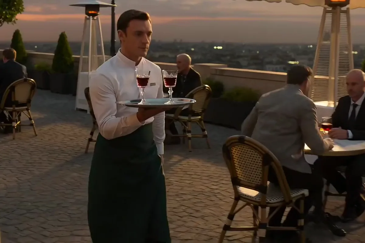Runway Gen-4.5 video of a waiter carrying two glasses of red wine across a cafe terrace at sunset