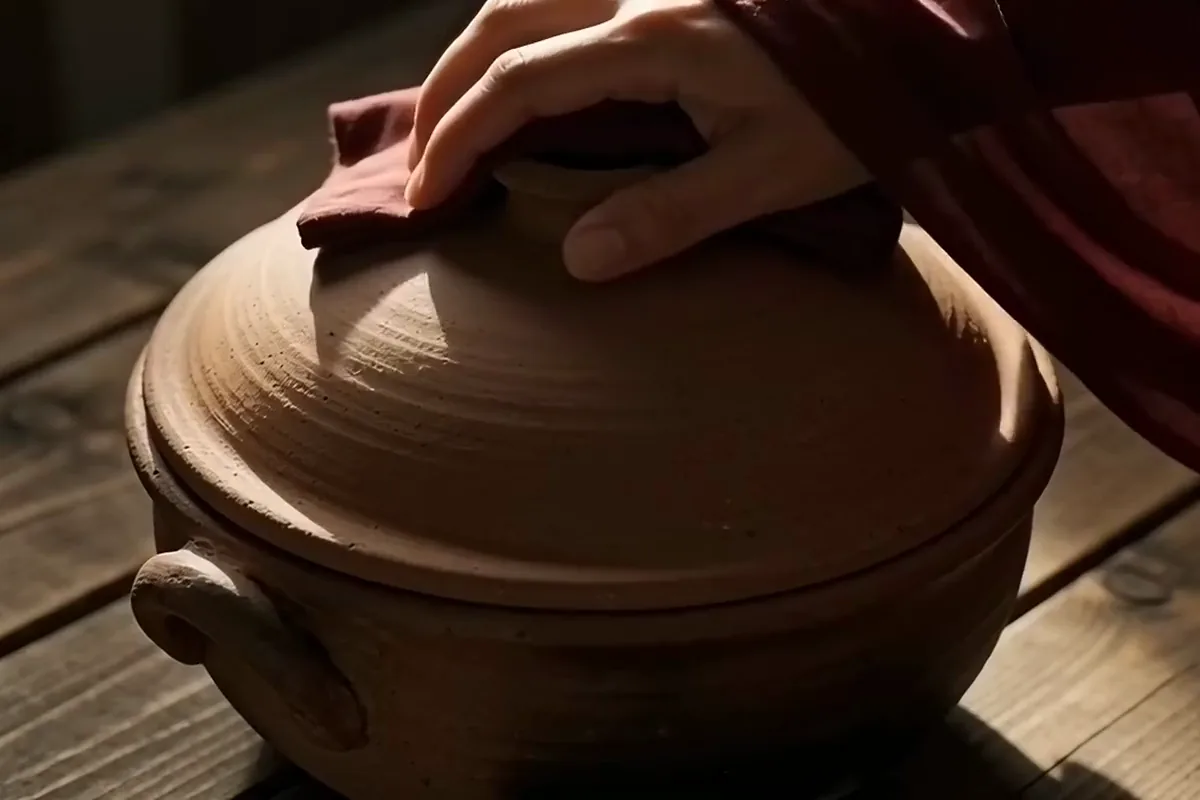 Seedance 2.0 video of a hand lifting the clay lid off a pot of saffron rice as steam rises