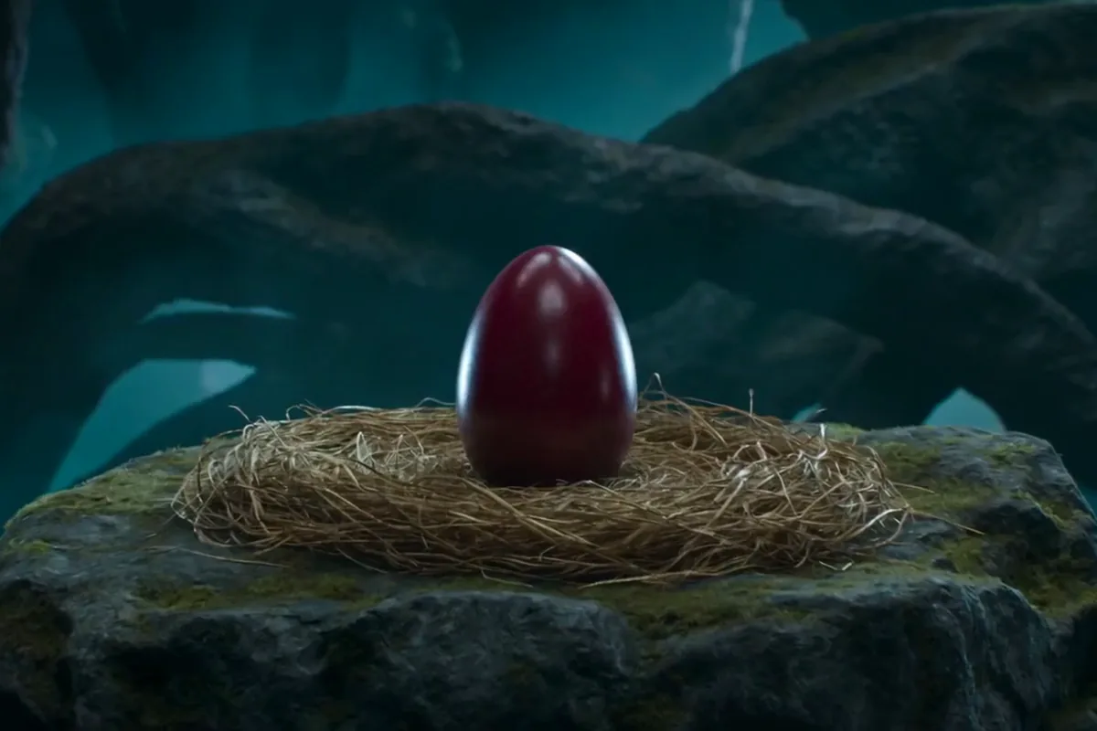 Text to video clip of a crimson egg hatching a baby dragon in a golden straw nest