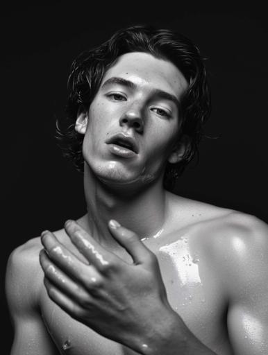 This striking black-and-white portrait features a shirtless young man with a defined, athletic physique and wet hair that drapes over his face, adding emotional depth. The lighting employs a single, diffused source from above and to the side, accentuating his musculature through a chiaroscuro effect with high contrast between light and shadows. Using a focused aperture, fast shutter speed, low ISO, and a portrait lens captures his contemplative expression with sharp detail, against a deep black background that isolates the subject, drawing attention to water droplets on his skin.