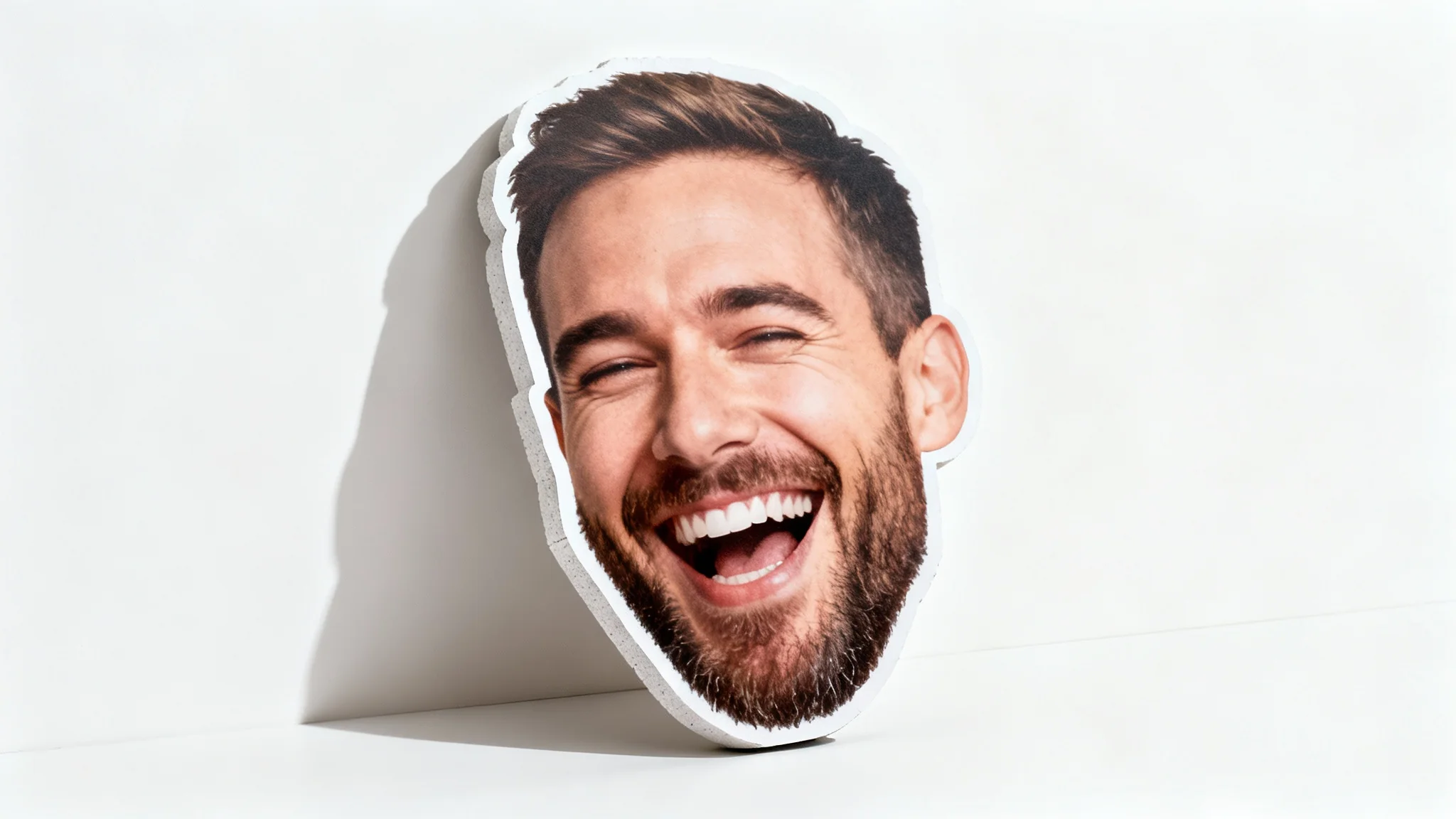 A photorealistic product mockup of a big head cutout featuring a laughing man's face, displayed against a stark white background.
