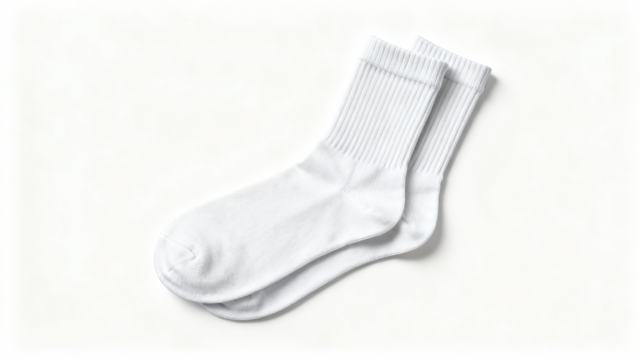 A photorealistic mockup of a pair of white crew socks, arranged neatly on a plain white background to showcase their texture and design.