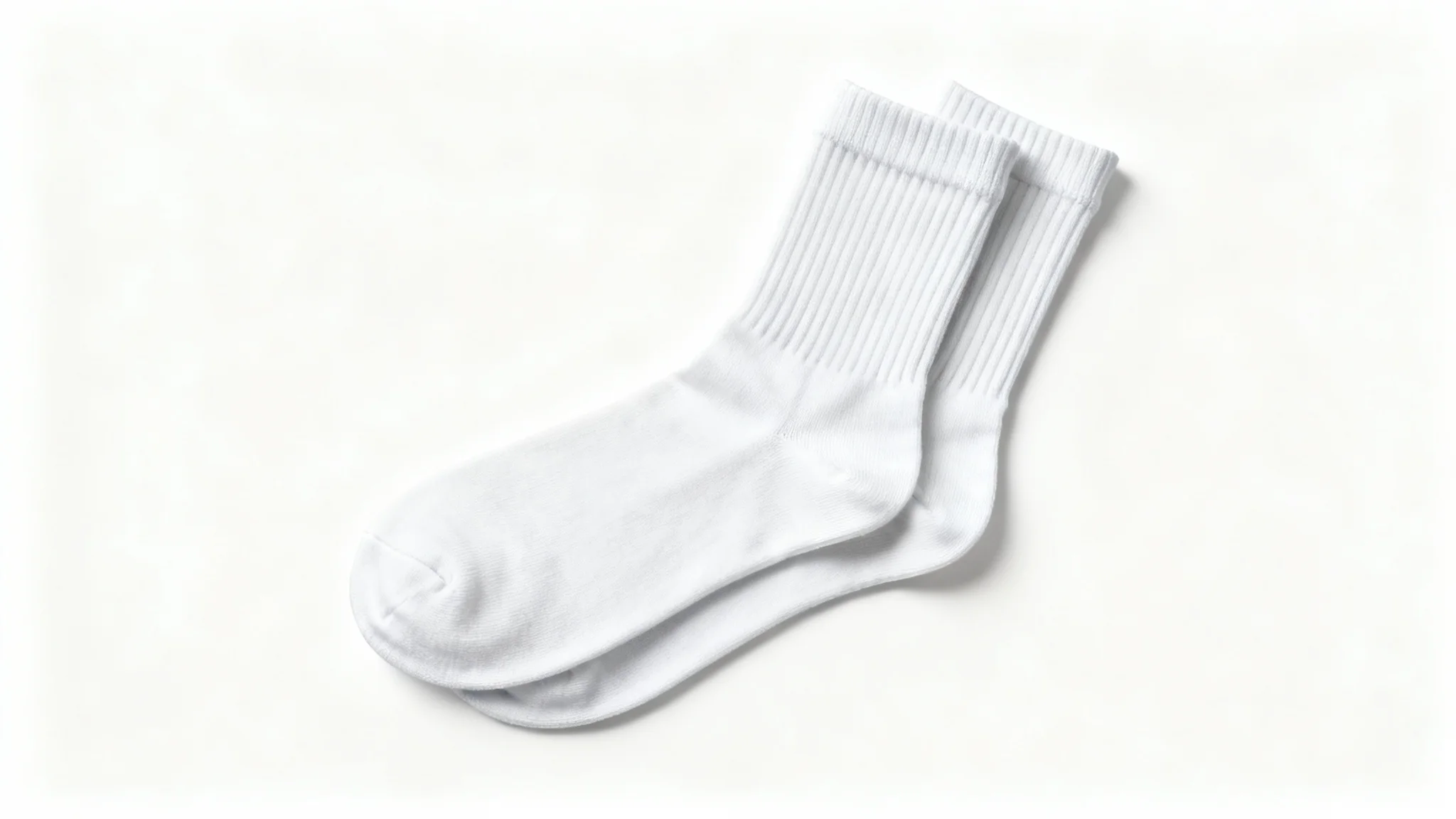 A photorealistic mockup of a pair of white crew socks, arranged neatly on a plain white background to showcase their texture and design.