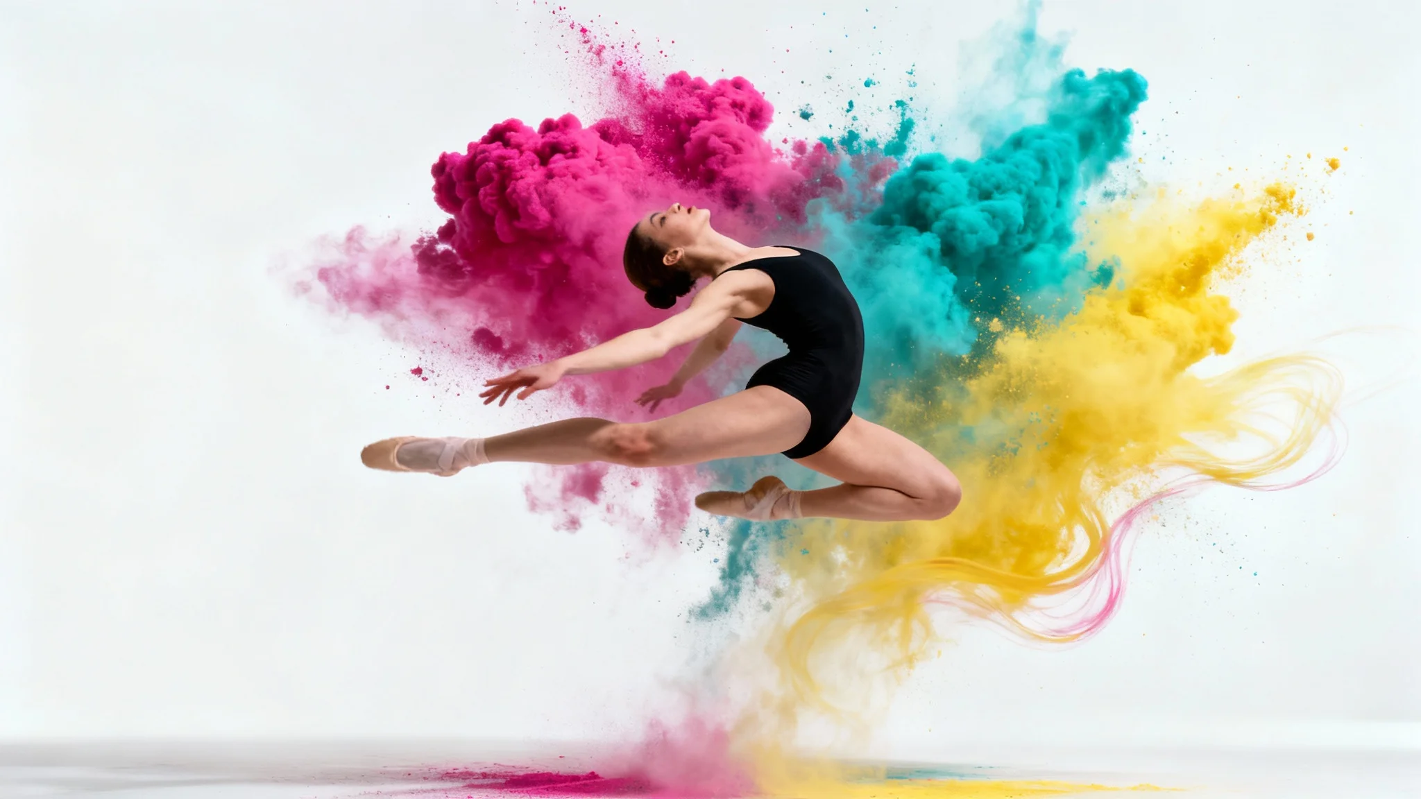 A female ballet dancer in a black leotard is captured mid-leap, surrounded by a vibrant explosion of magenta, cyan, and yellow powder against a clean white background.