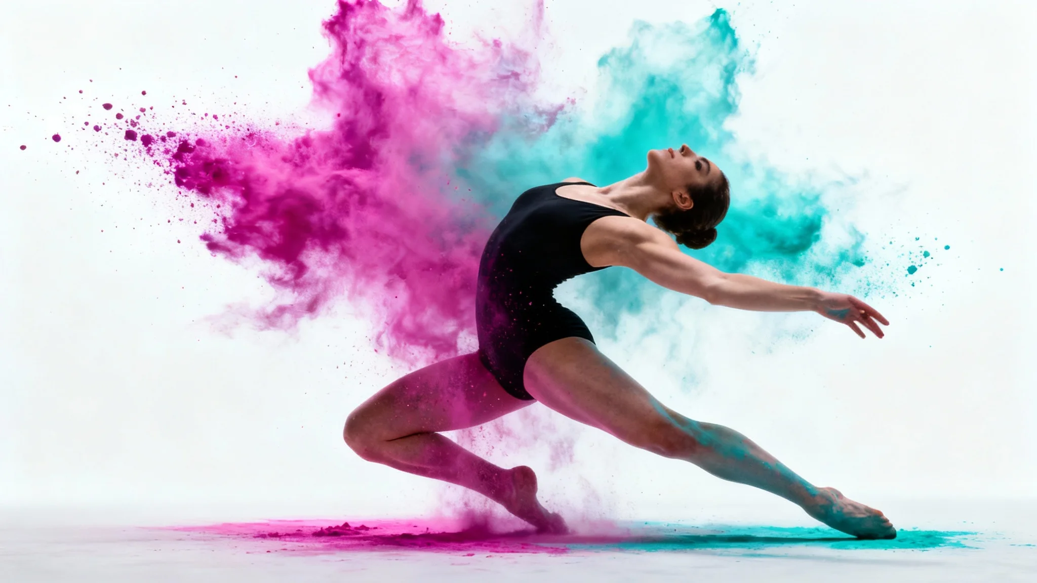 A female contemporary dancer in a black leotard is captured mid-motion against a white background, surrounded by an explosion of vibrant pink and blue powder frozen in time.