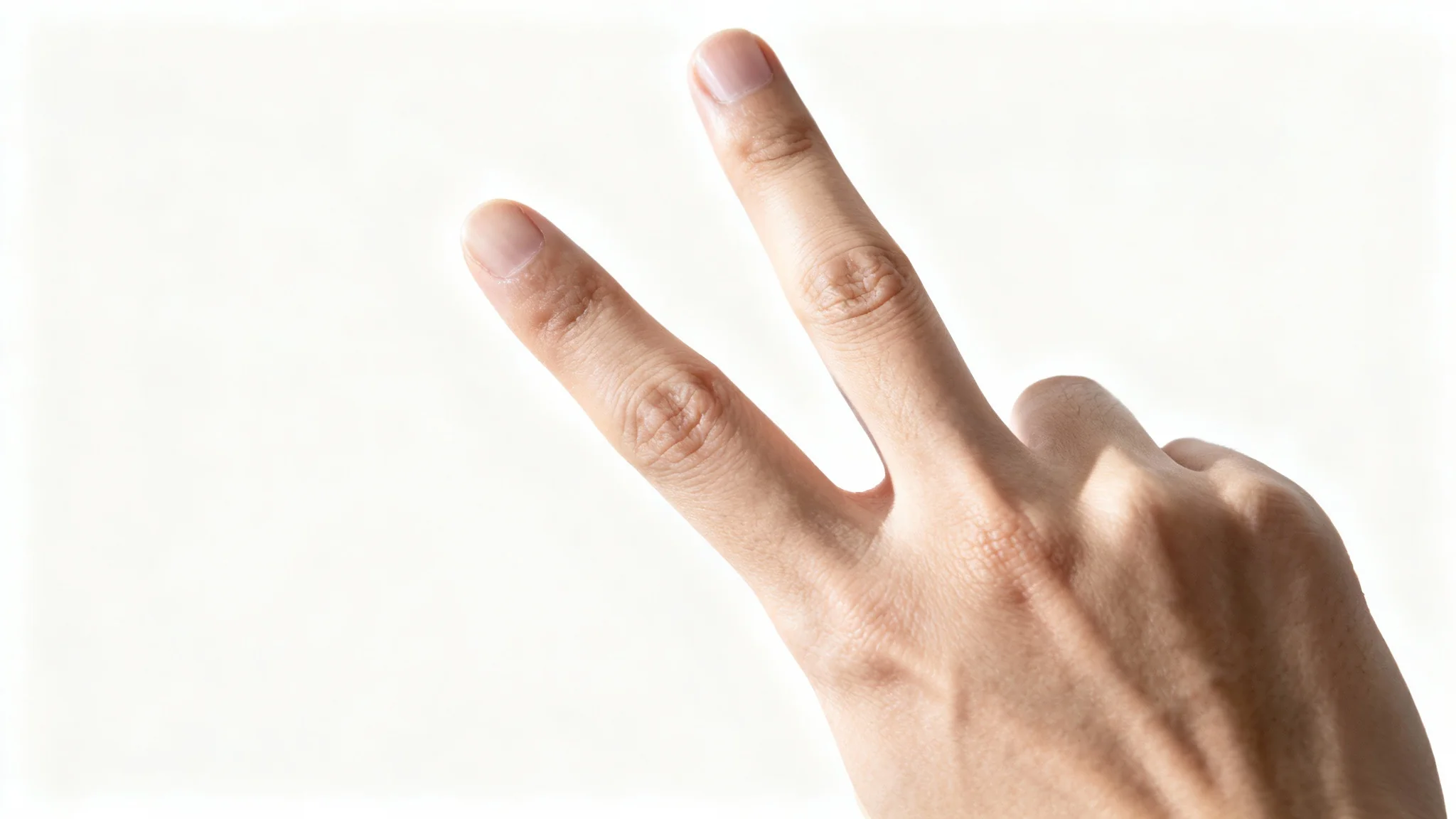 A close-up, photorealistic image of a human hand making a peace sign against a stark white background.