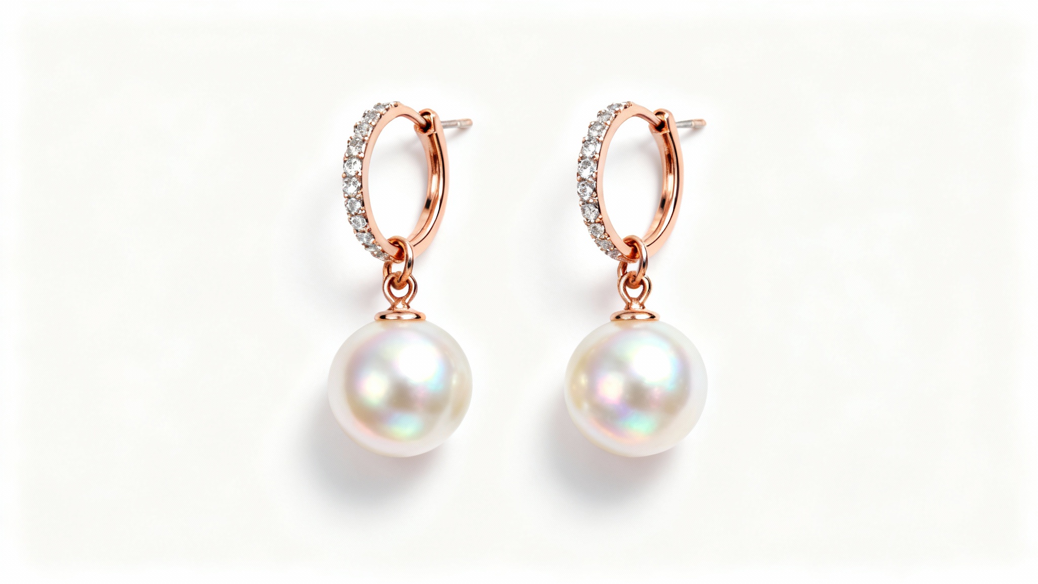 A professional product photograph of elegant rose gold earrings with round freshwater pearls and diamond accents, shot in a studio with a clean white background.