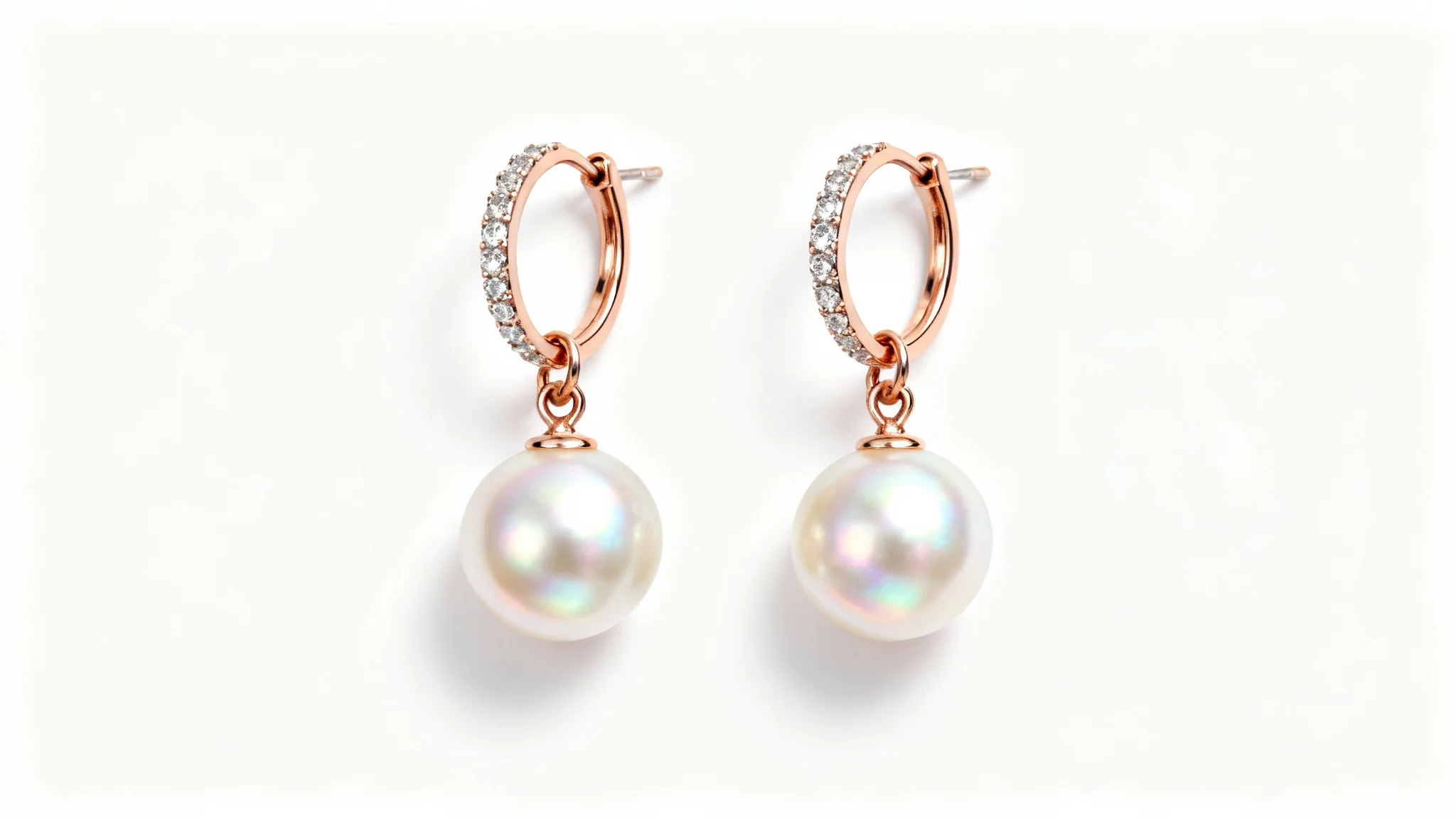 A professional product photograph of elegant rose gold earrings with round freshwater pearls and diamond accents, shot in a studio with a clean white background.