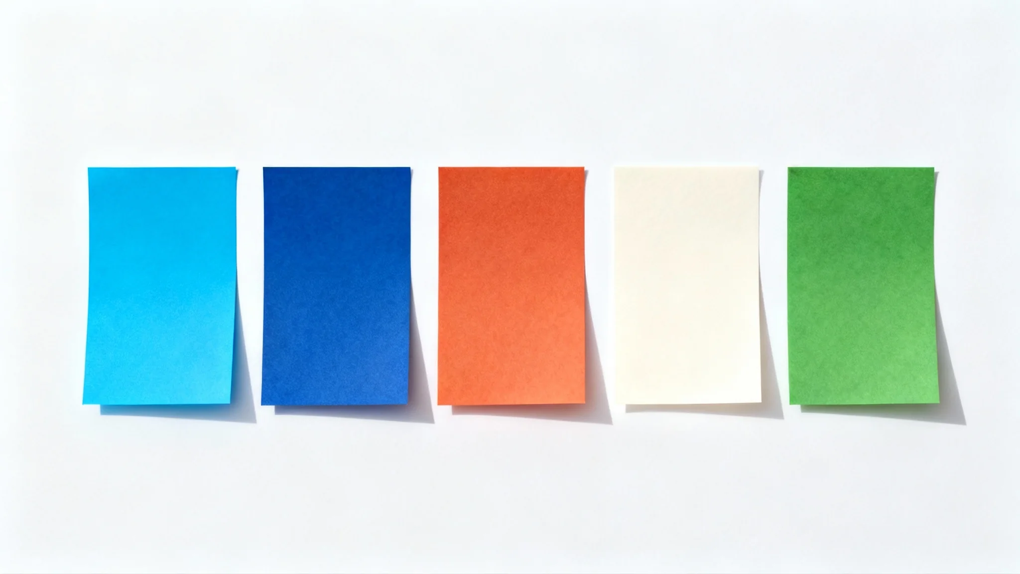 A top-down view of five rectangular color swatches arranged in a row on a white background, representing the 'Bluey' color palette with shades of blue, orange, cream, and green.