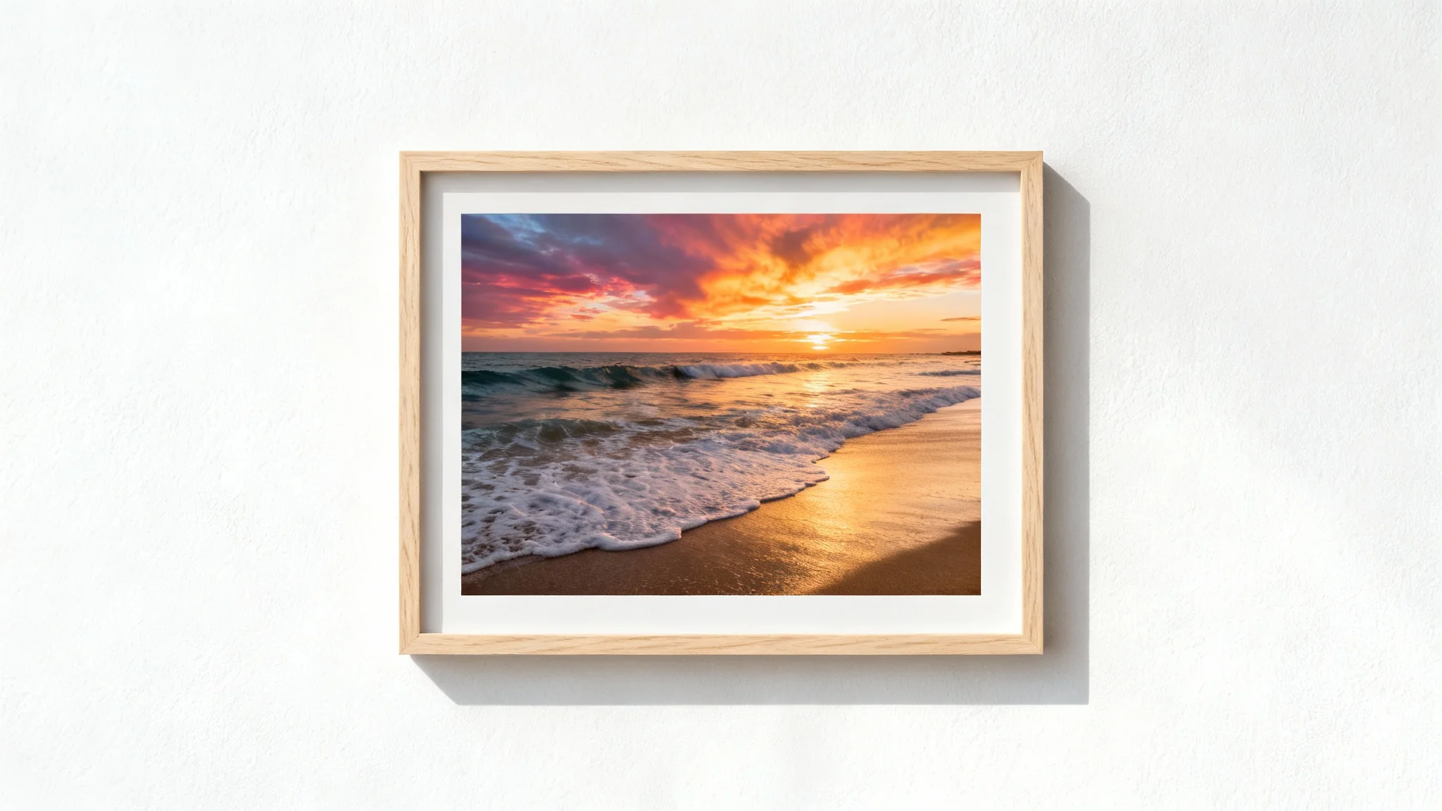 A minimalist mockup of a horizontal light wood frame on a white wall, containing a photograph of a beautiful beach sunset.