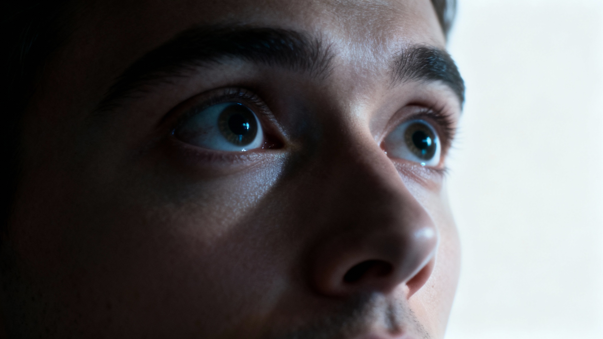A dramatic close-up photo of a person's face showing an expression of surprise and intrigue, symbolizing the captivating effect of a strong video hook.