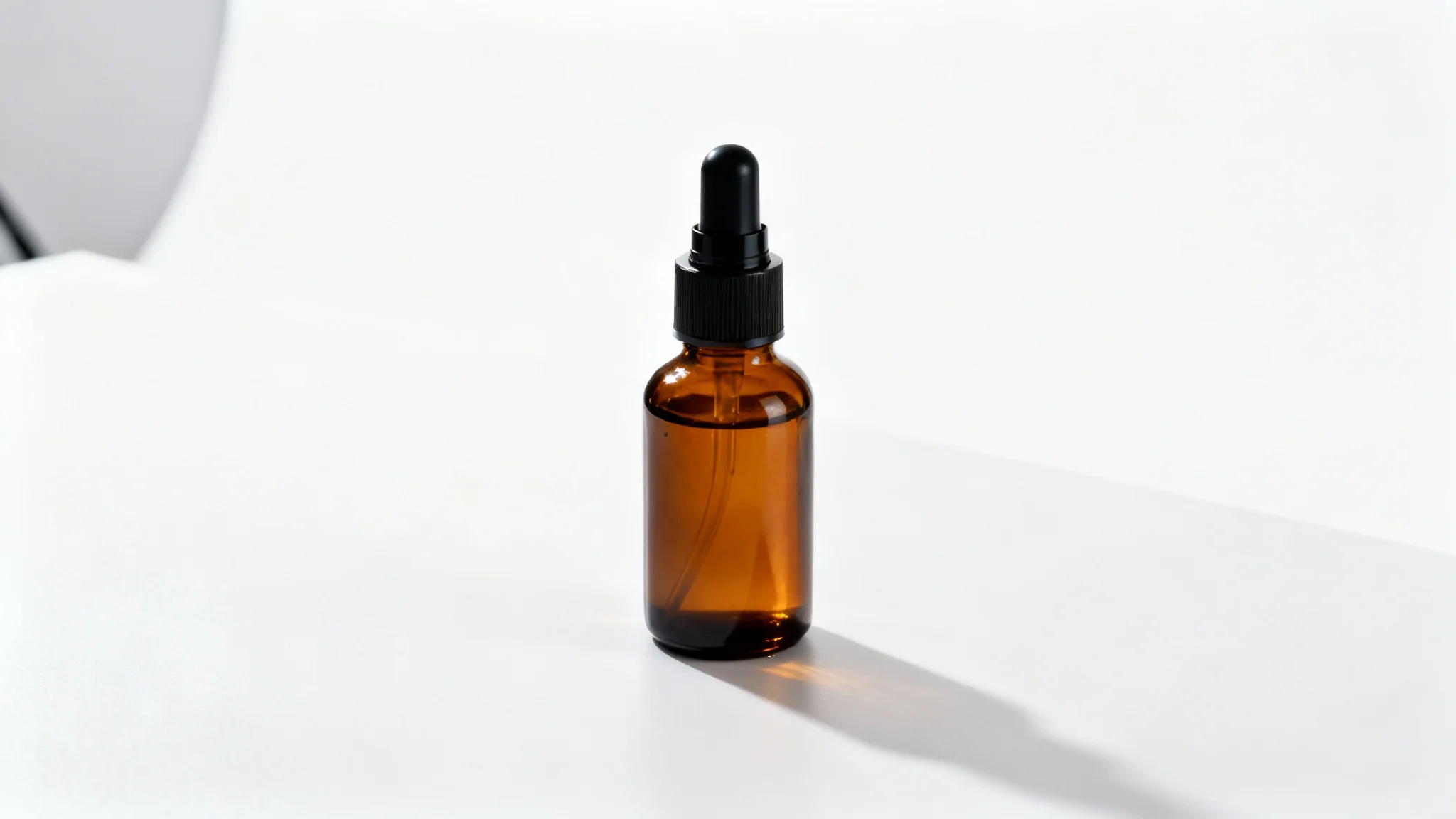 A professional studio product photograph of a sleek amber cosmetic bottle with a black pump, sitting on a clean white surface against a seamless white background.