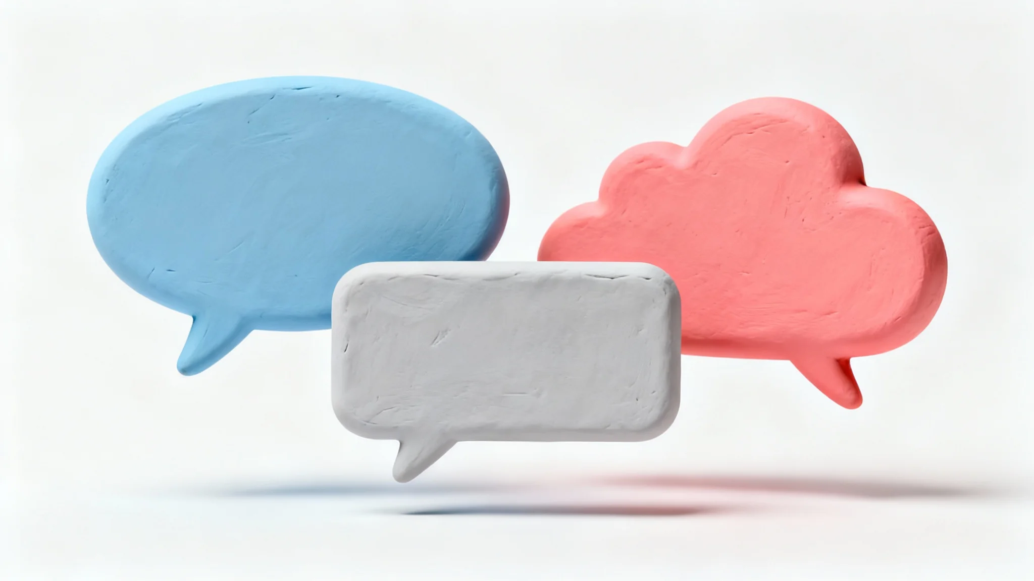 A collection of 3D-rendered speech bubbles in pastel blue, gray, and coral pink, floating in various shapes against a clean white background.
