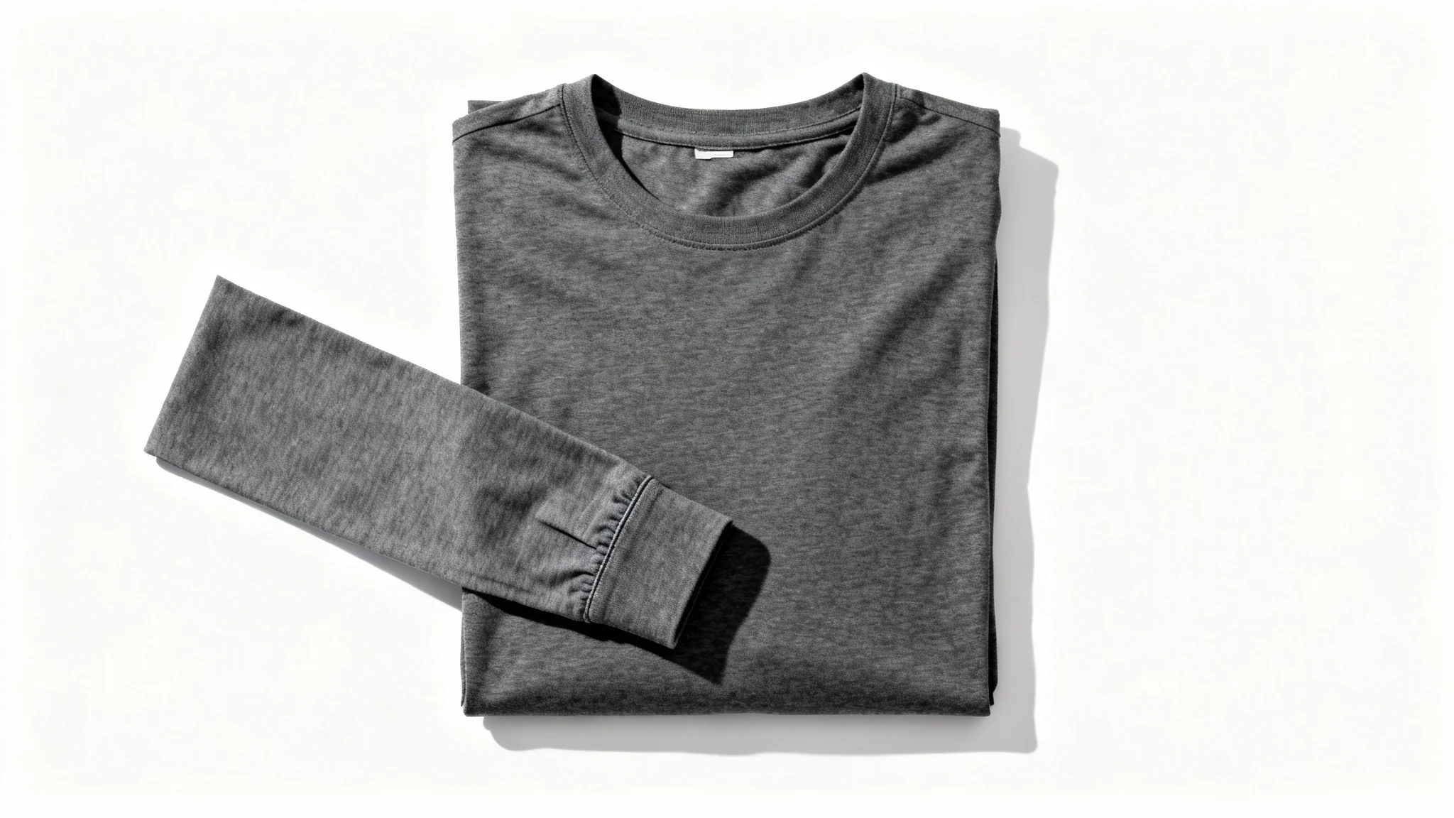 A flat lay product mockup of a charcoal grey long-sleeve shirt neatly arranged on a solid white background.