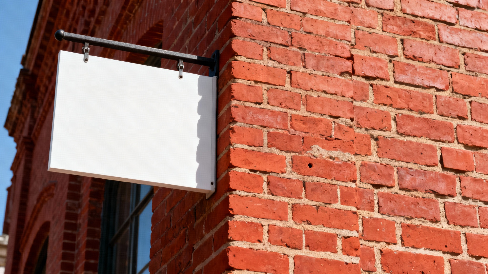 A close-up photograph of a clean, historic red brick wall, perfectly restored with no signs or marks, demonstrating a sign removal effect.