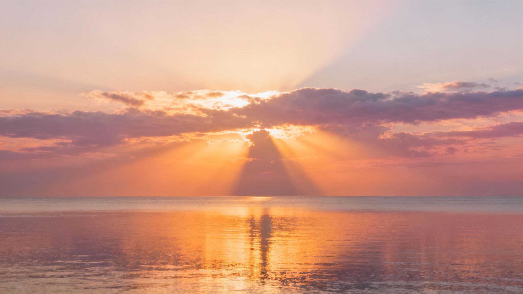 A serene and majestic sunrise over a calm ocean, with golden rays of light breaking through the clouds, creating a peaceful and spiritual atmosphere suitable for a bible verse background.