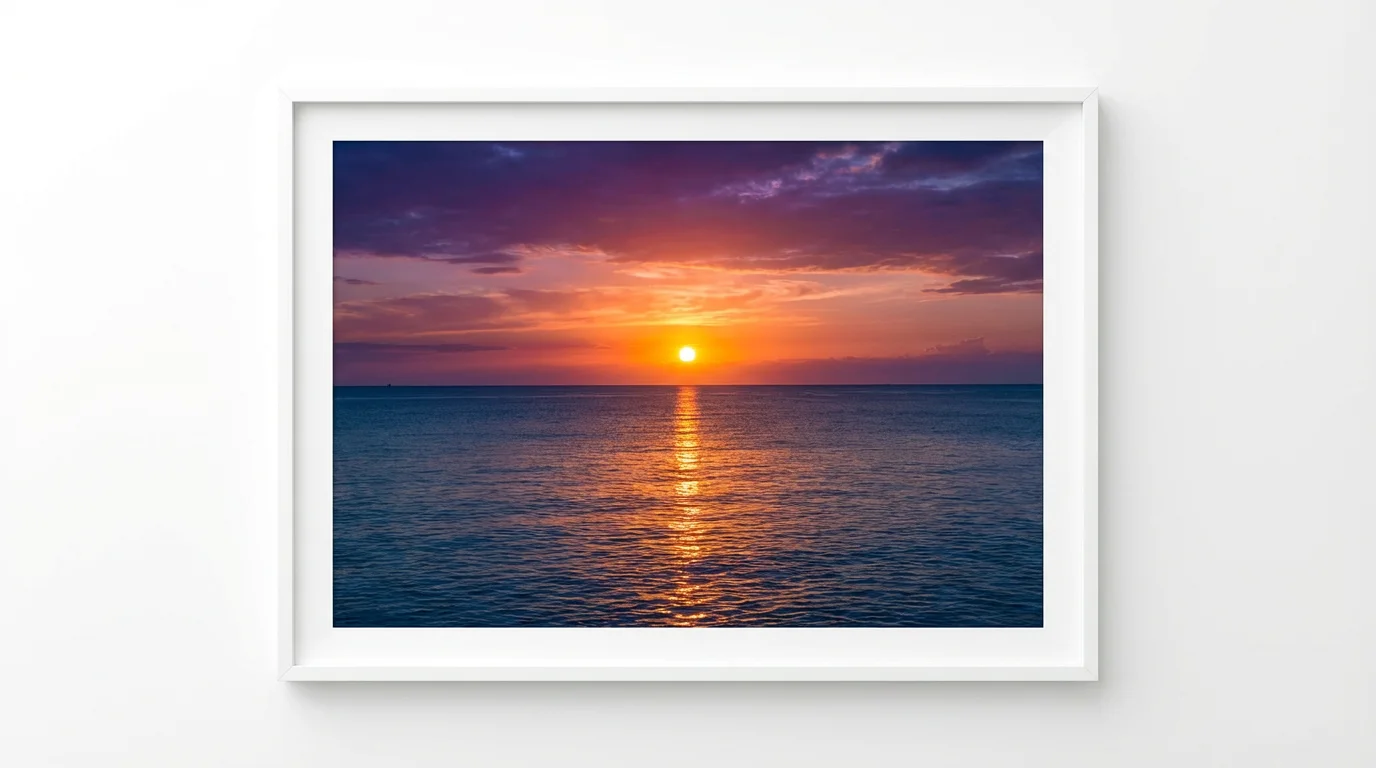 A stunning, photorealistic image of a vibrant sunrise over a calm ocean, with the sun on the horizon casting a golden reflection on the water. The image is presented as a mockup against a plain white background.