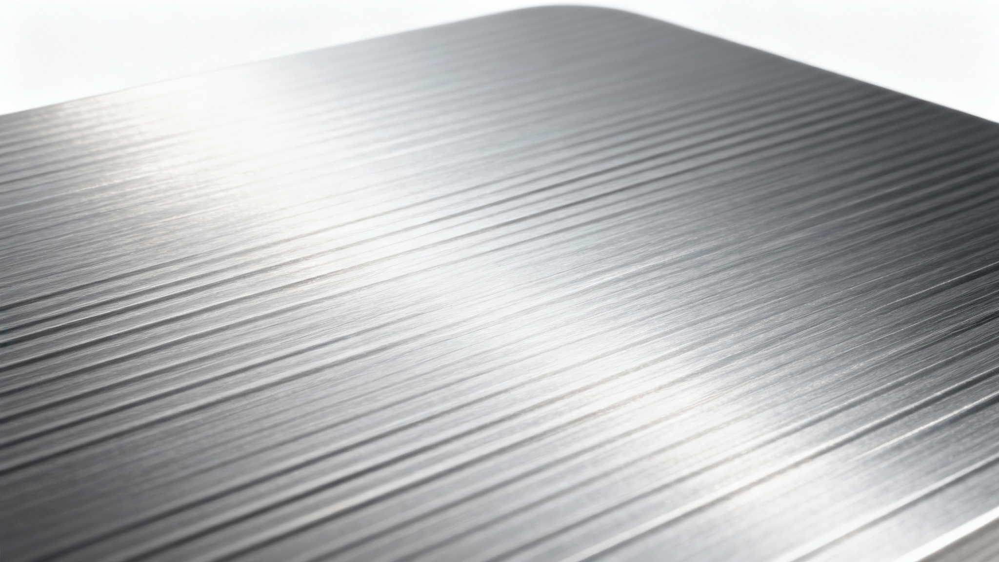 A detailed, close-up image of a brushed aluminum texture with fine horizontal lines and a metallic sheen, set against a plain white background.