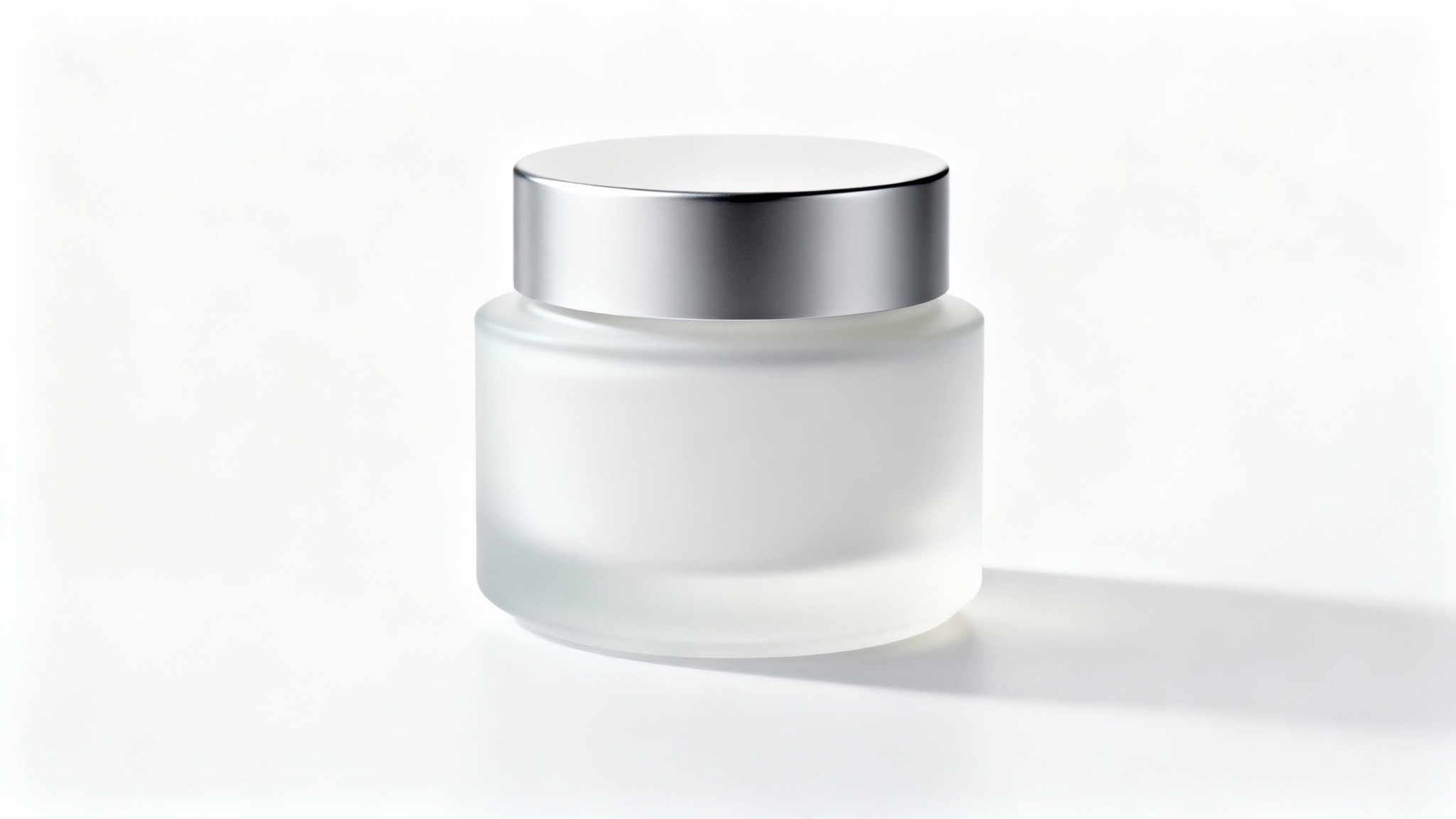 A professional product photograph of a luxurious, white frosted glass moisturizer jar with a silver lid, set against a clean, seamless white background in a studio setting.