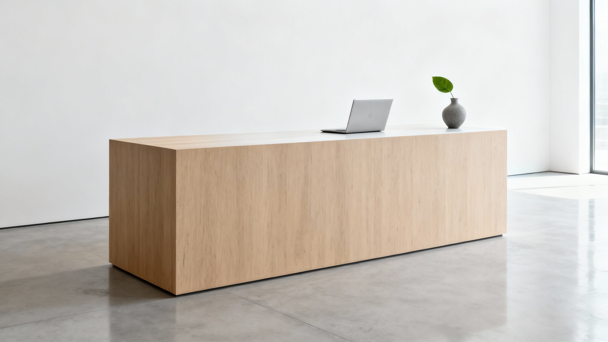 A photorealistic image of a minimalist reception desk made of light oak, featuring a closed silver laptop and a small vase, set in a bright, modern lobby with a white background.