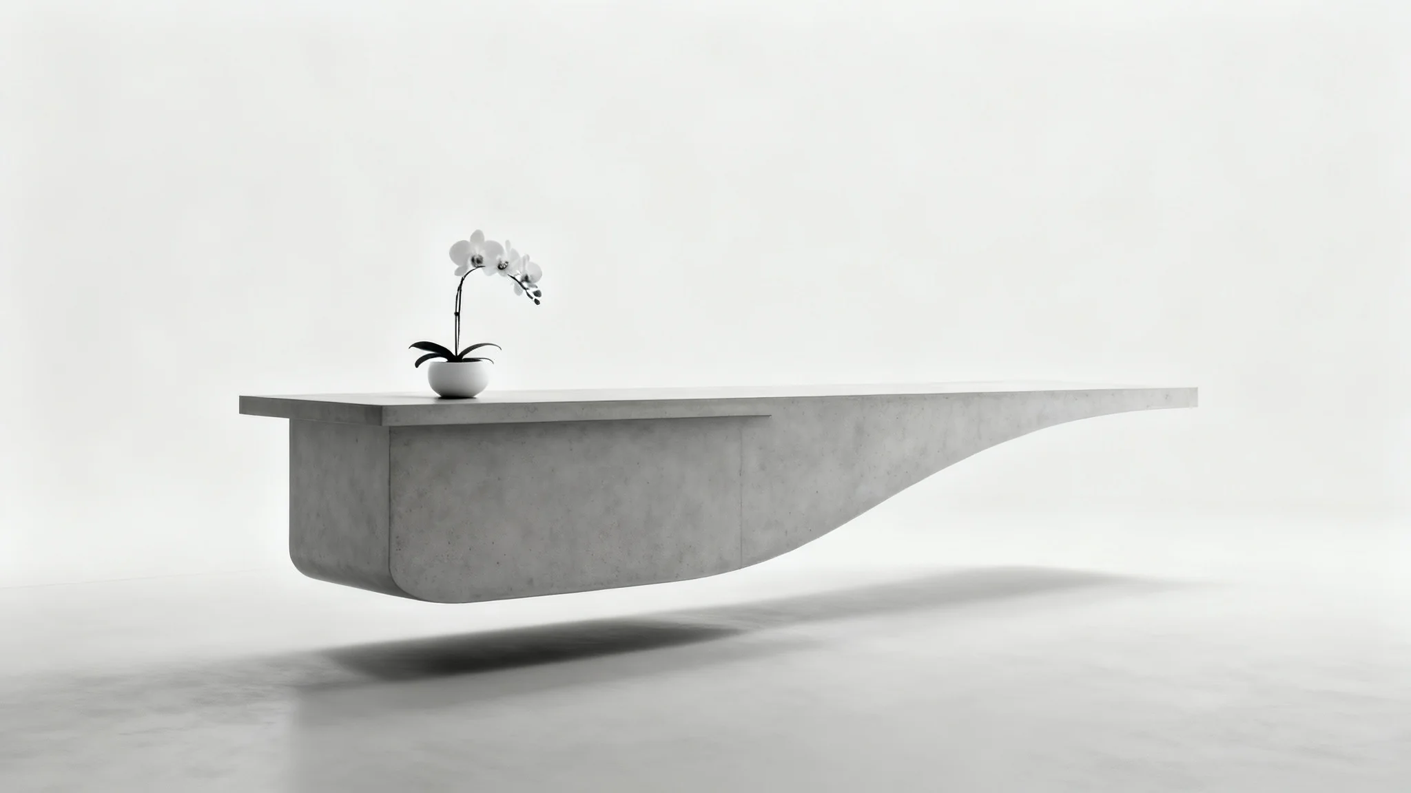A minimalist reception desk made of curved, light gray concrete, with a single orchid plant on top, set against a plain white background.