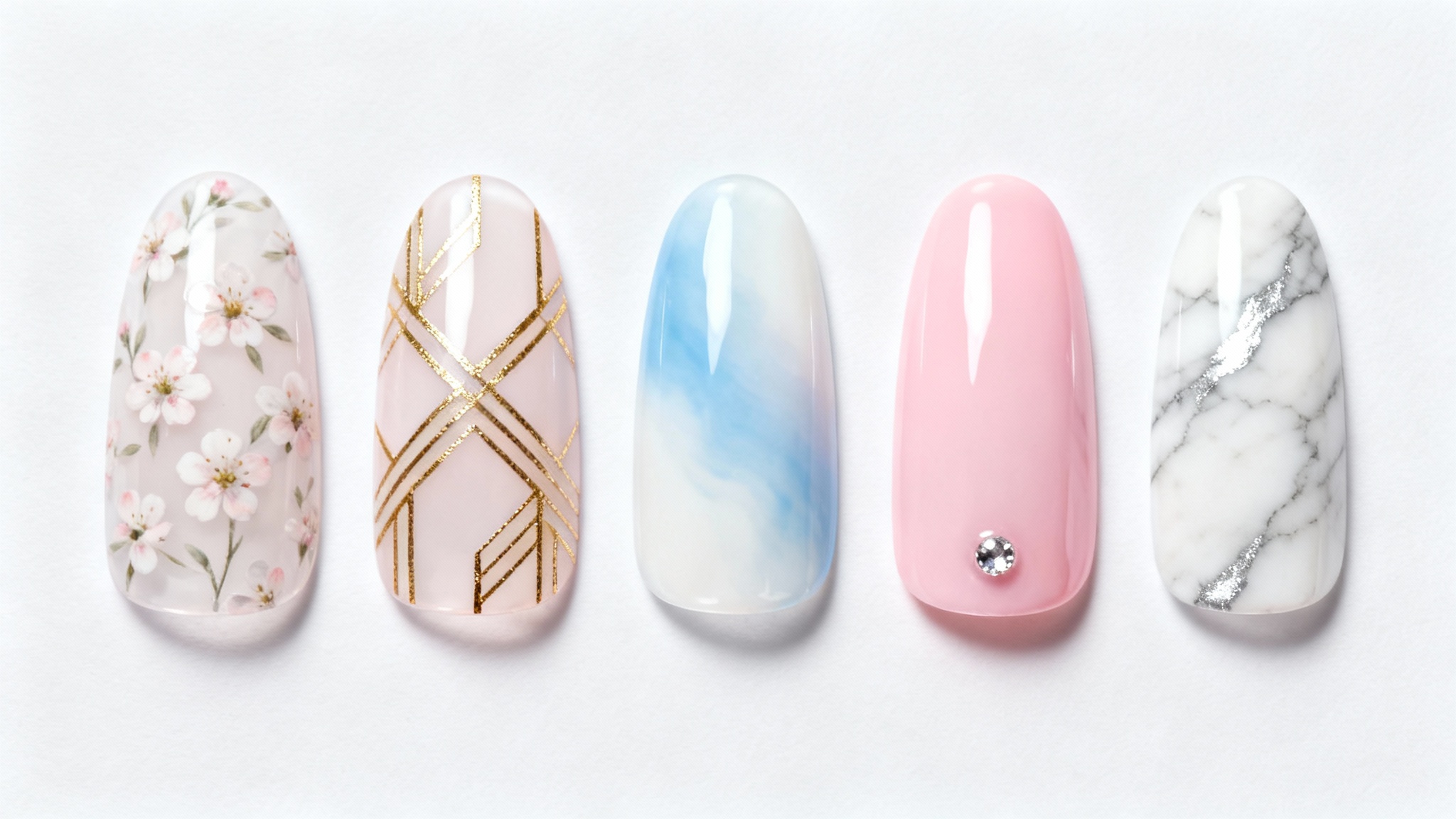 A collection of five sample nail tips with different, intricate designs including floral, geometric, and ombre patterns, displayed against a clean white background.
