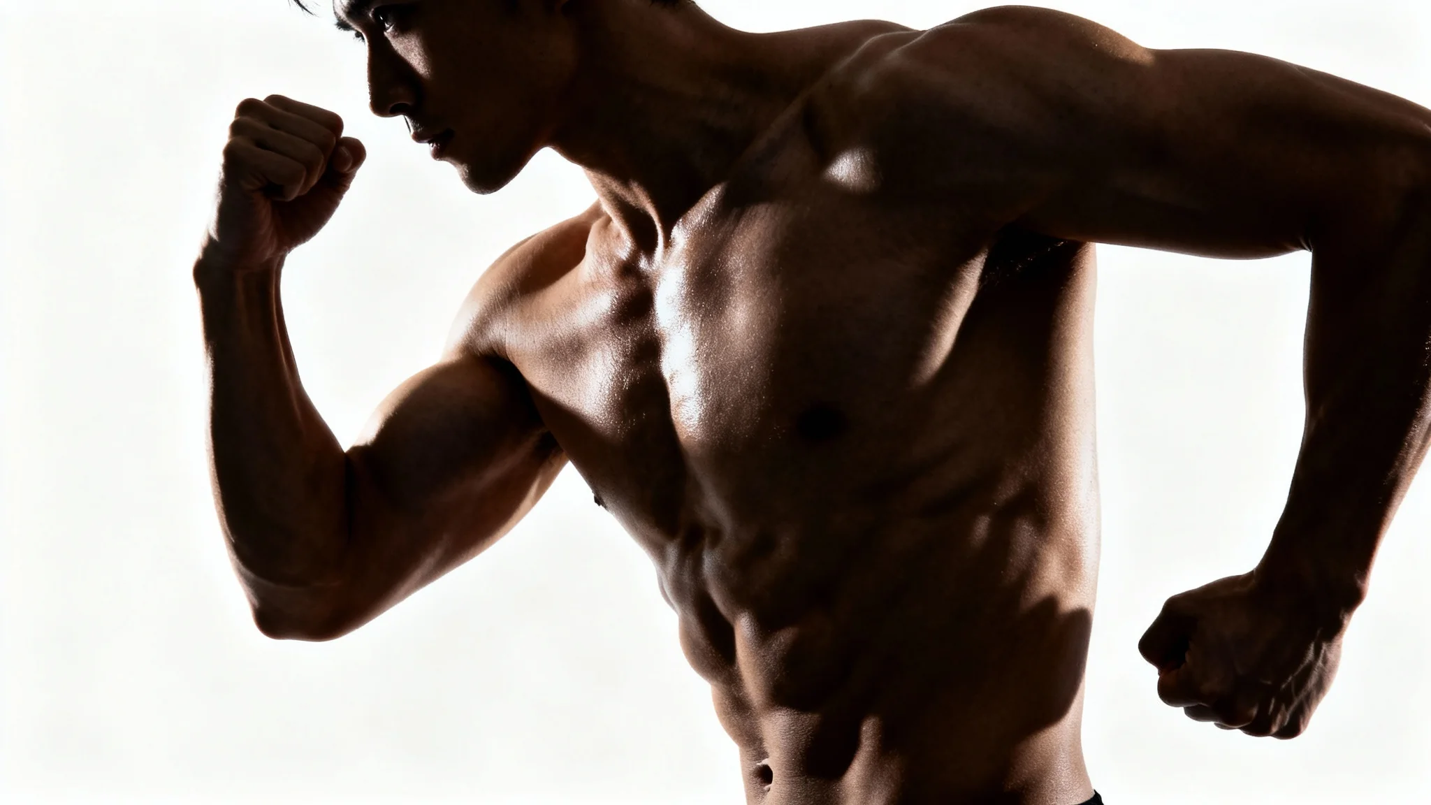 An upper-body studio photograph of a muscular person with highly defined abs, chest, and arm muscles, set against a plain white background.