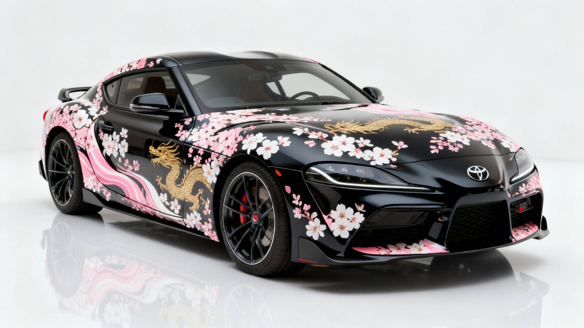 A modern black Japanese sports car with a custom Japanese-inspired livery of pink cherry blossoms and a subtle gold dragon, shown in a white studio setting.
