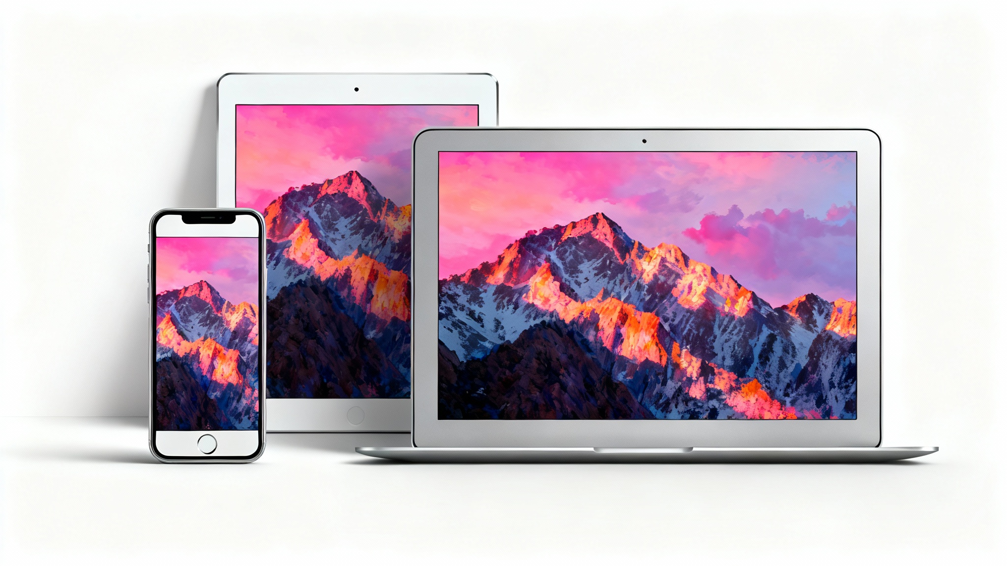 A mockup showing a smartphone, tablet, and laptop, each displaying the same colorful mountain landscape wallpaper perfectly resized to fit their different screens, against a clean white background.
