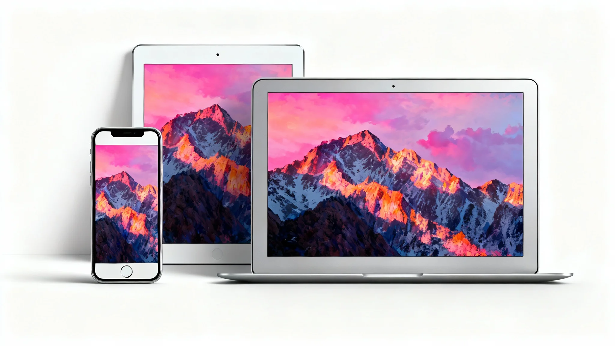 A mockup showing a smartphone, tablet, and laptop, each displaying the same colorful mountain landscape wallpaper perfectly resized to fit their different screens, against a clean white background.
