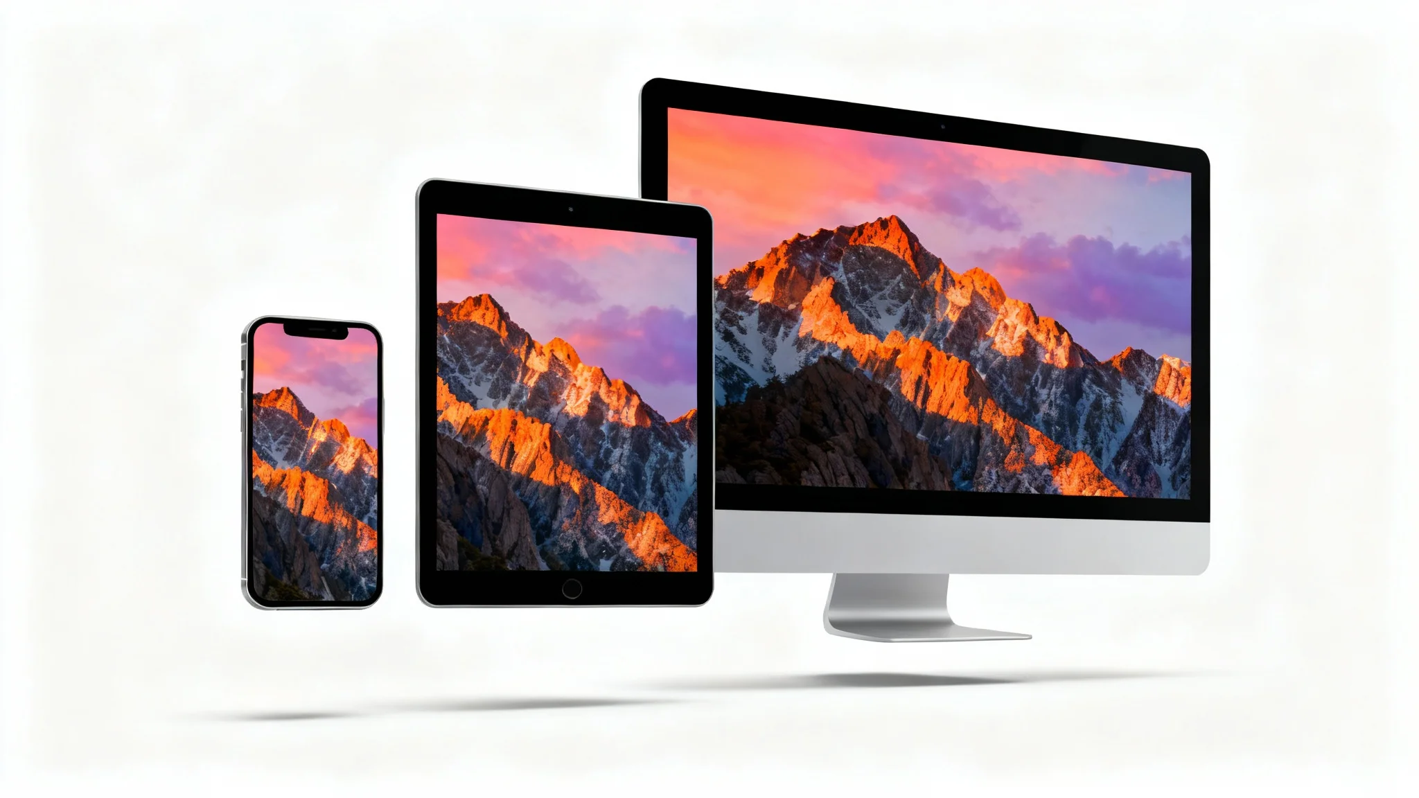 A smartphone, tablet, and desktop monitor lined up, each showing the same mountain sunrise wallpaper perfectly resized for its screen, against a white background.