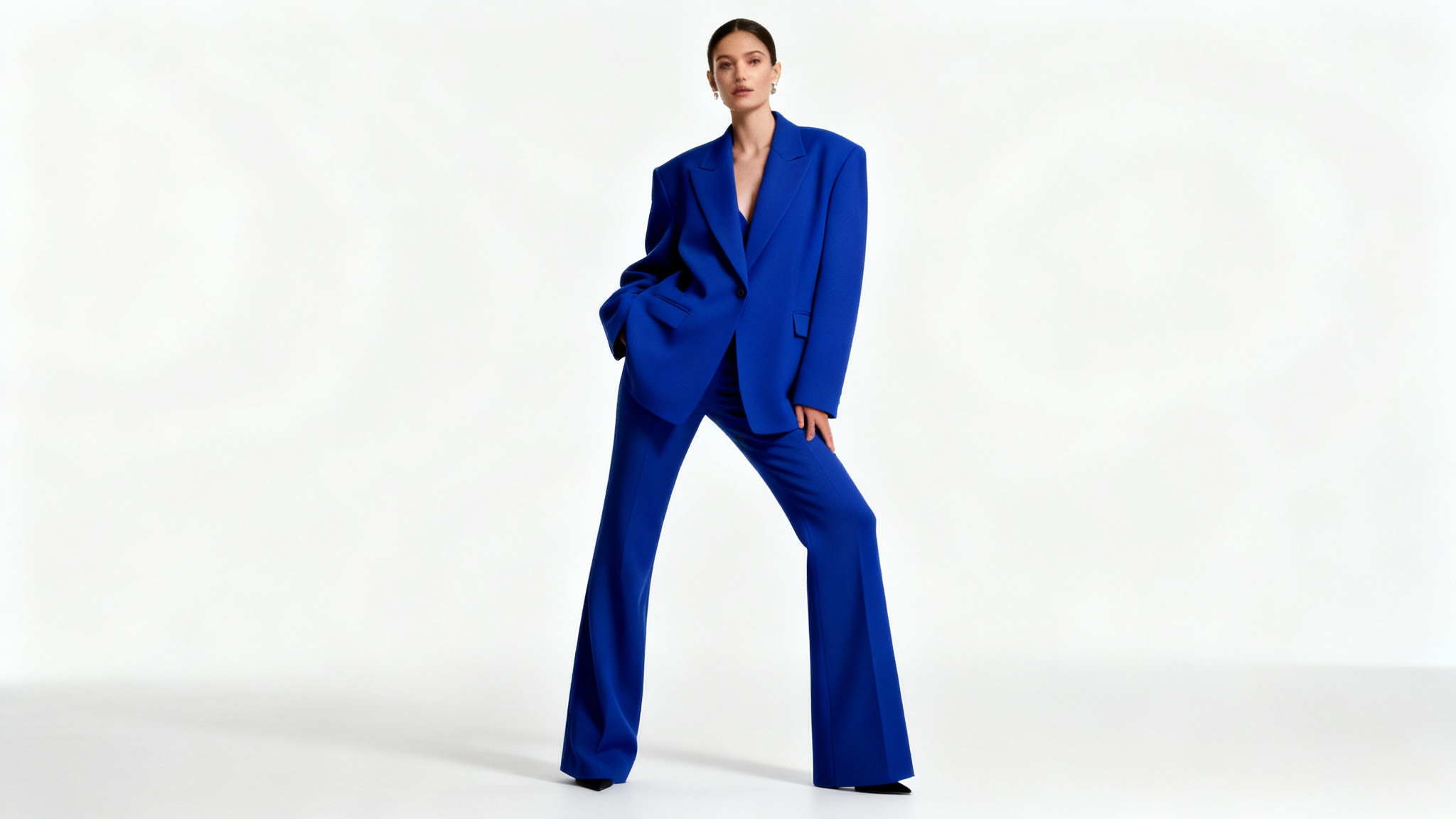 A photorealistic, full-body image of a woman posing confidently in a stylish blue suit against a plain white background, created by an AI image generator.