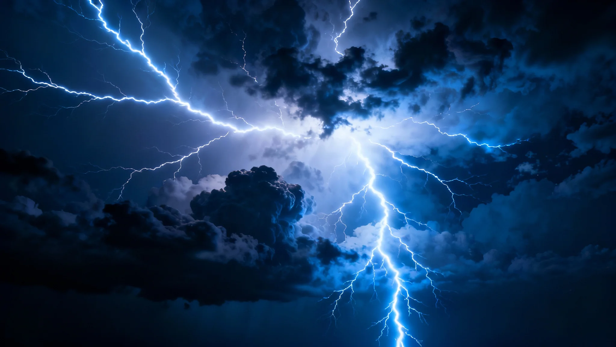 A dramatic, high-resolution background image of a powerful thunderstorm at night, with bright white and blue lightning bolts filling the dark sky.