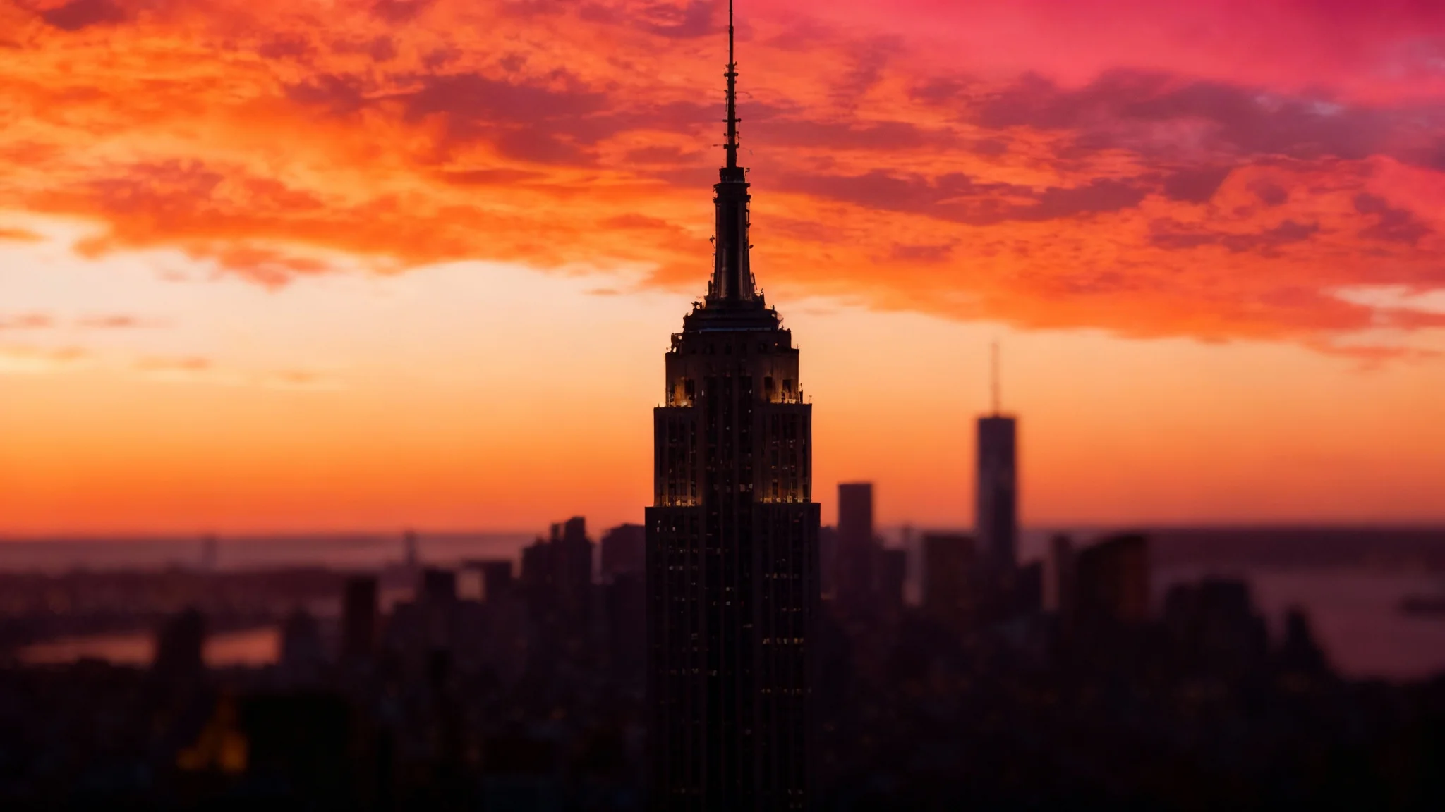 A close-up photograph showing the result of a smart crop, featuring a single skyscraper perfectly framed against a vibrant sunset sky.