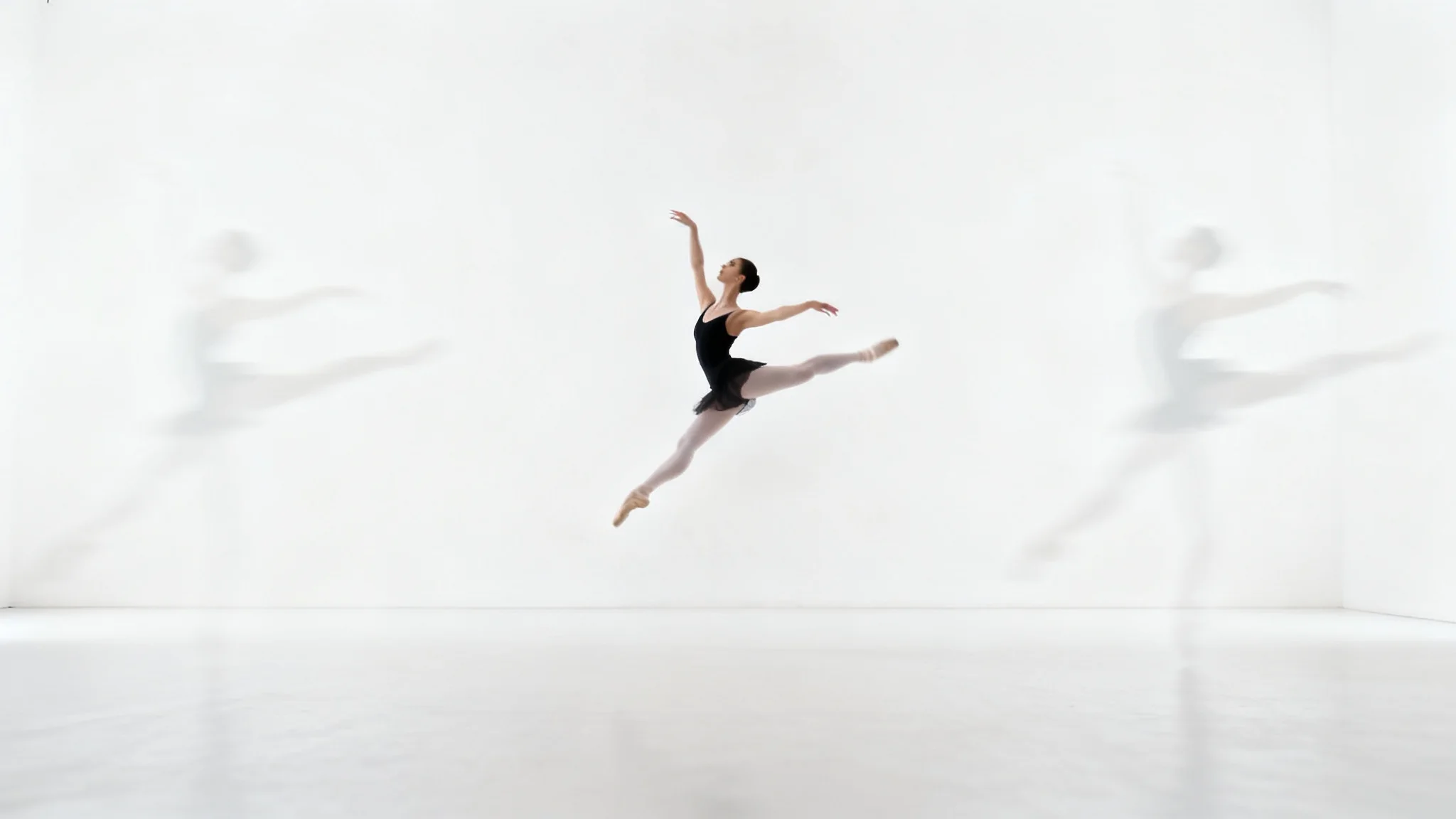 A conceptual photo illustrating a smart crop, featuring a perfectly framed shot of a leaping ballet dancer in focus, with faint, blurred outlines suggesting the larger, uncropped original image, all set against a plain white background.