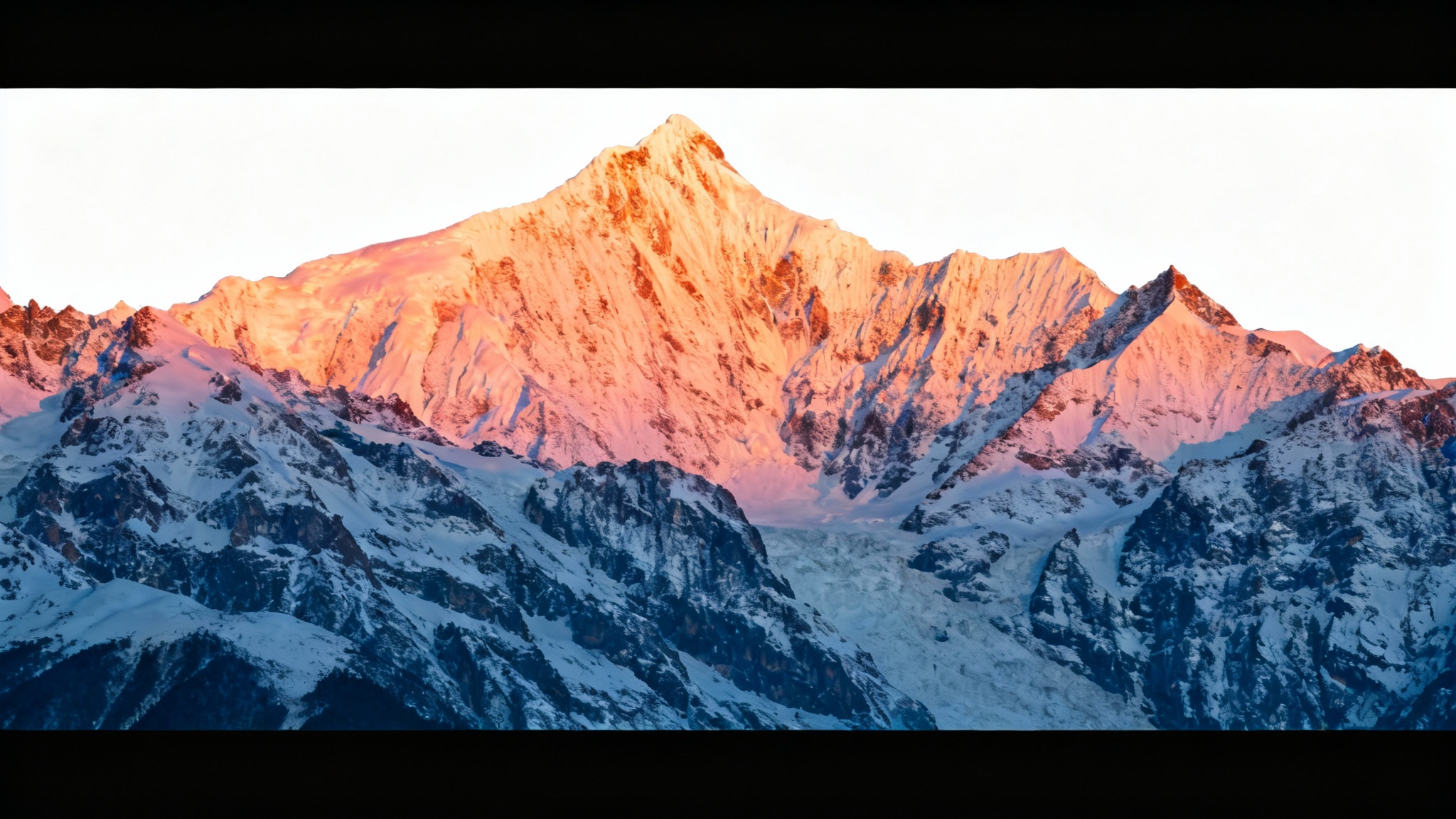 A photo of a mountain range at sunset that has been modified with black bars at the top and bottom to create a cinematic, widescreen appearance, presented against a white background.