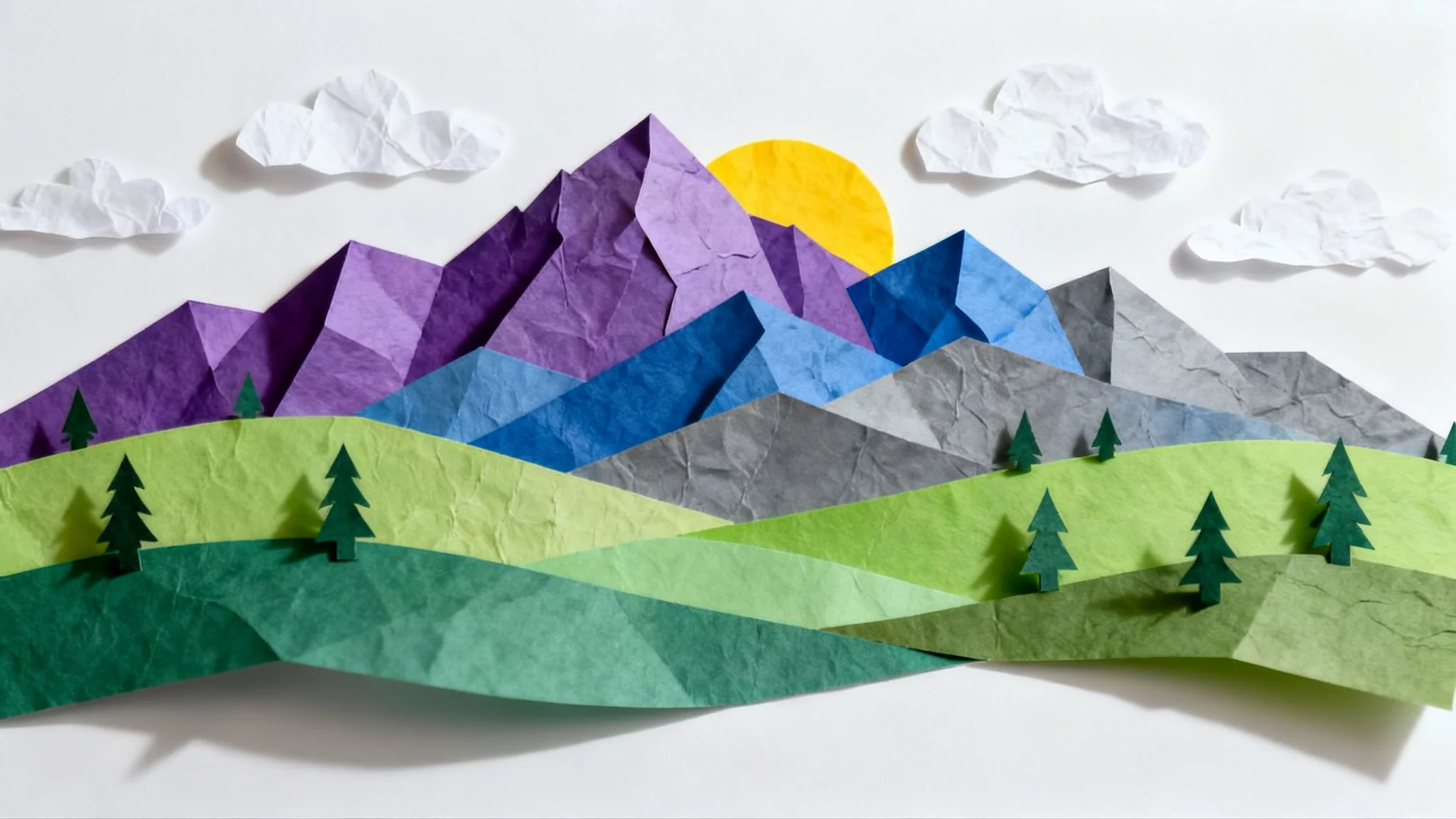 A vibrant landscape made from layered paper cutouts, featuring purple mountains, green hills, and a yellow sun, all casting soft shadows to create a 3D effect against a white background.